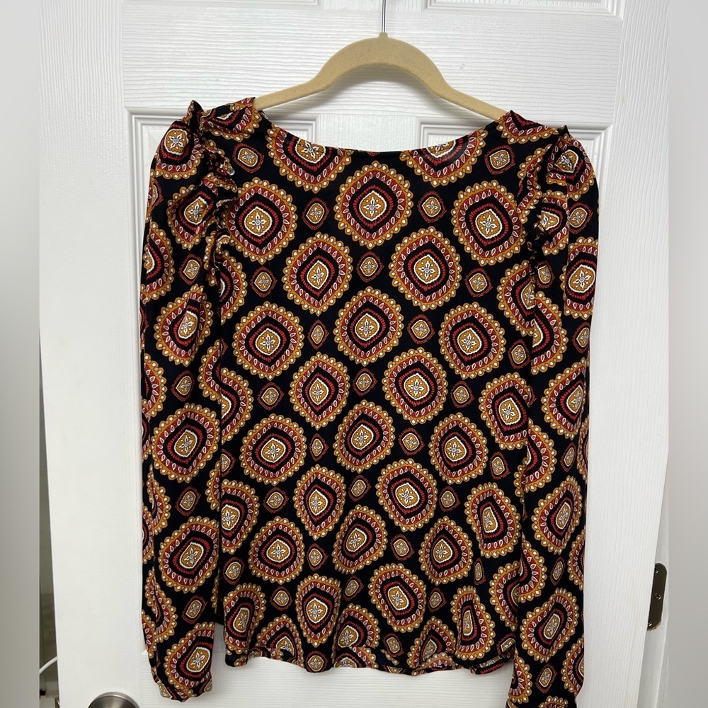LOFT multi-colored blouse with ruffle detail at shoulder and cut-out at back.